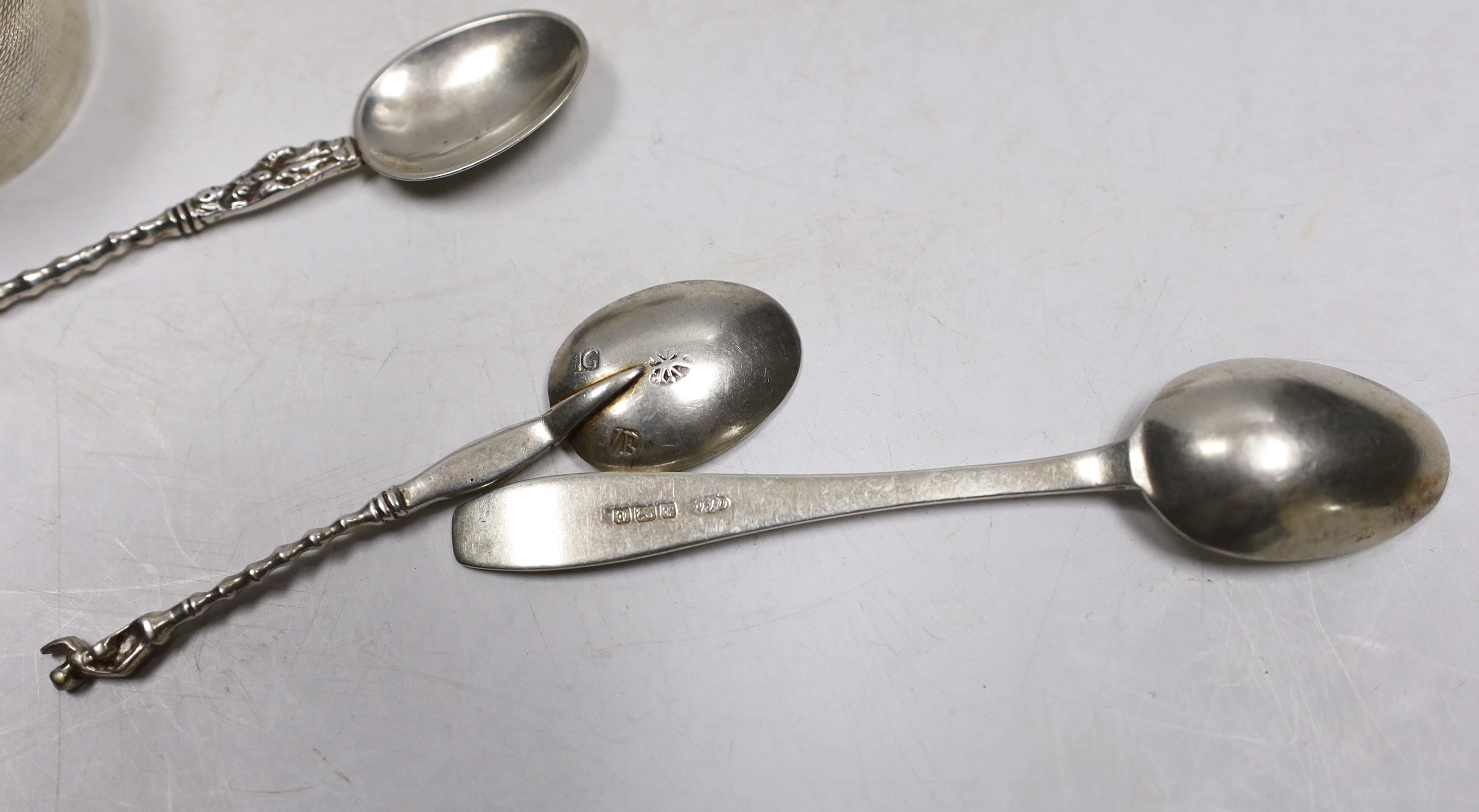 Four assorted silver napkin rings, six assorted silver coffee spoons including four with 'imp' terminals and four continental white metal coffee spoons.